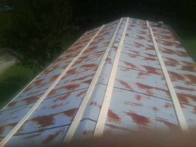 Rusted metal roof panels with new wood purlins before replacement — Storm Damage Roof Repair in Tinley Park by Roofing Brothers