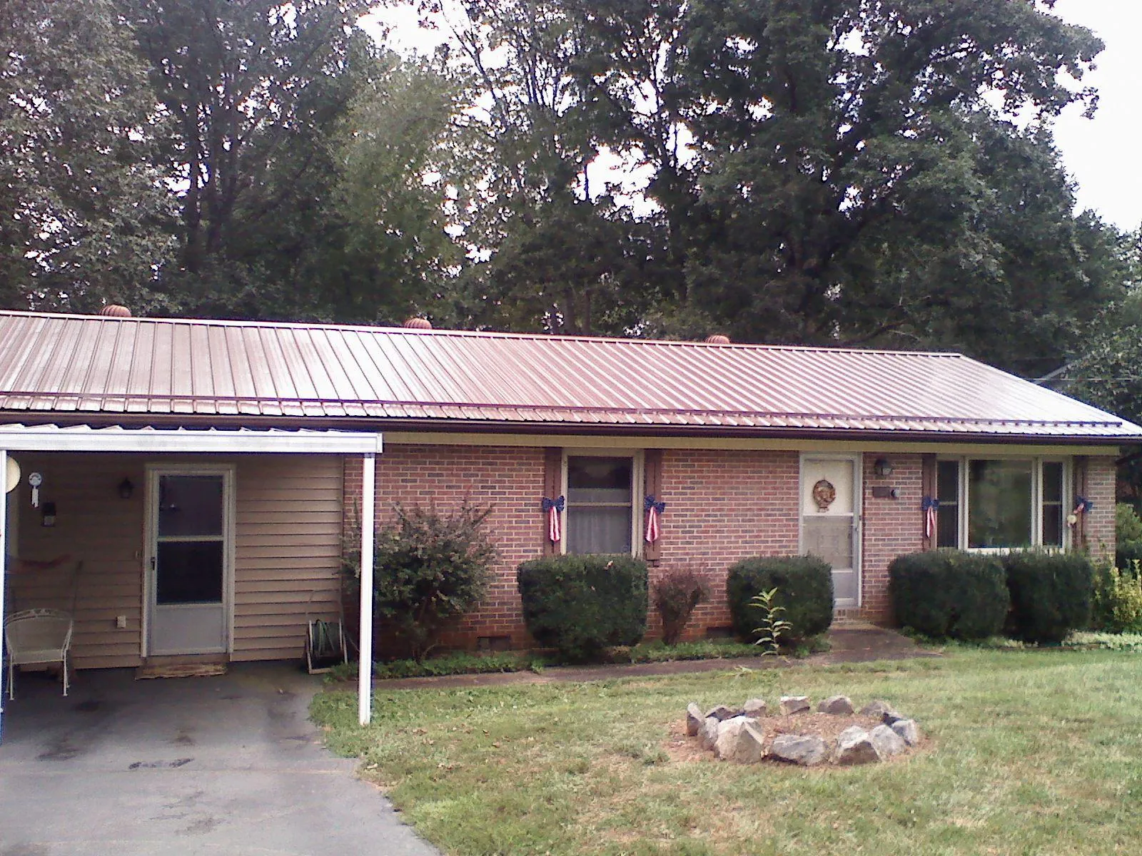 Bronze metal roof and carport on a brick ranch home — Roof Repair work by our crew in Tinley Park