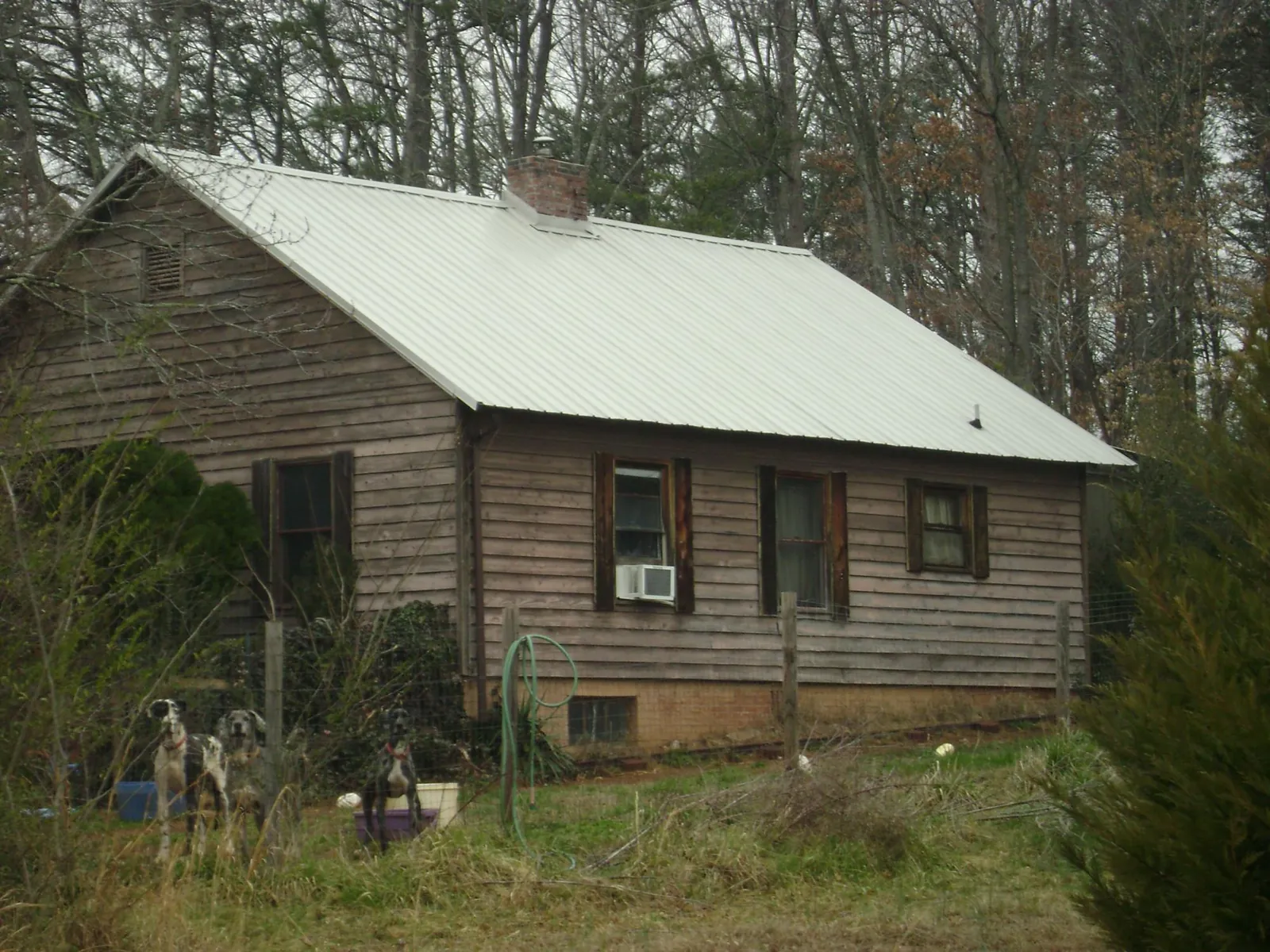 White metal roof on an old wood sided farmhouse, from a Metal Roof Installation job in Tinley Park